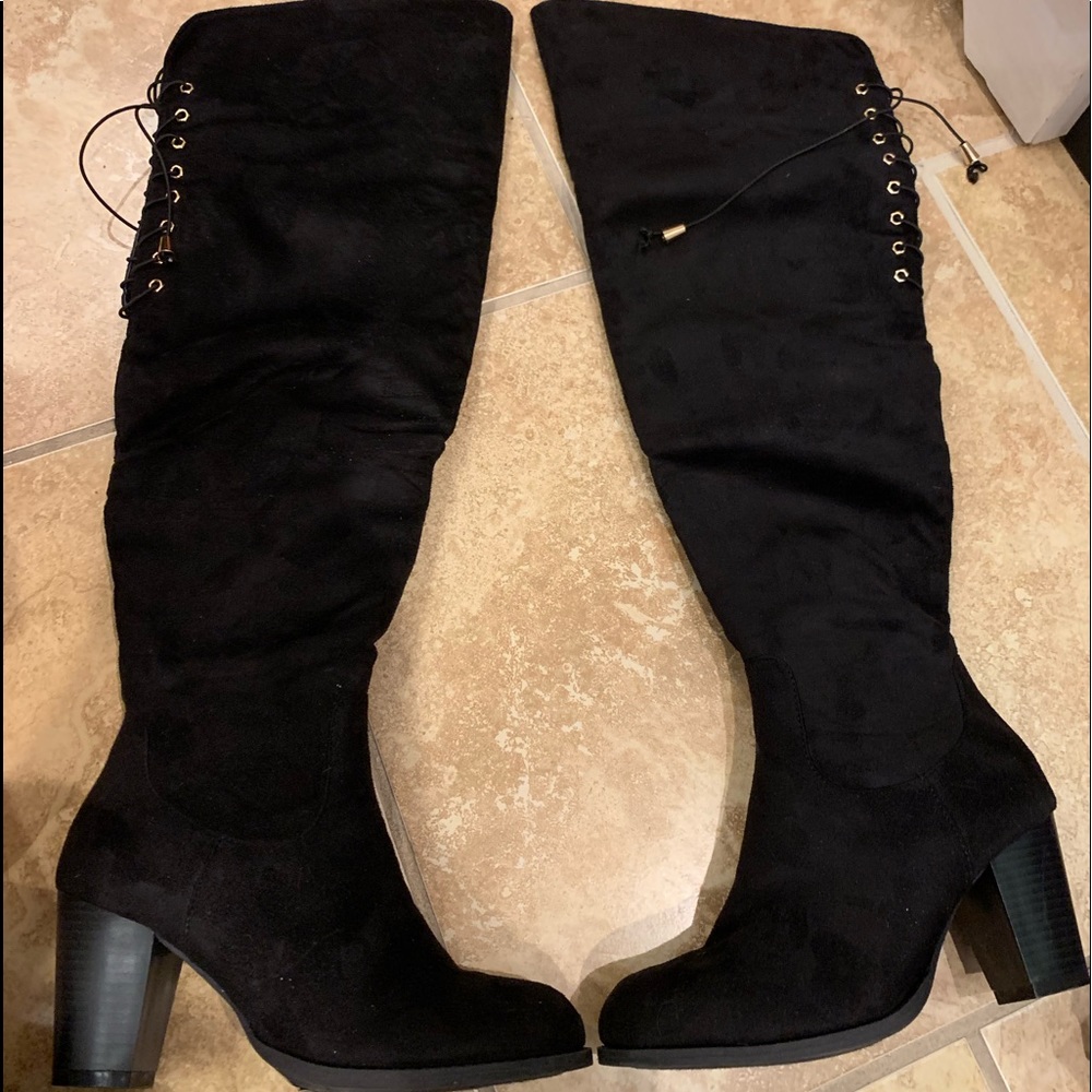 Black heeled boots over the knee